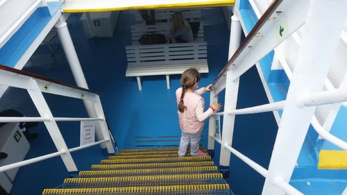 High angel view of girl on steps in boat