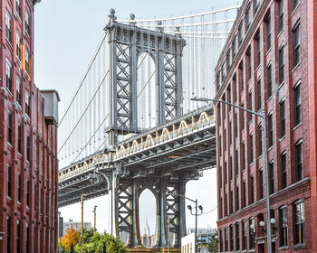 Iconic view of manhattan bridge from washington street. red brick street buildings brooklyn. nyc