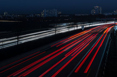 High angle view of light trails on road at night