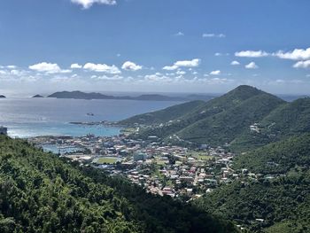 High angle view of townscape by sea against sky