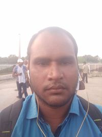 Portrait of man in city against clear sky