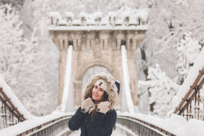 Portrait of woman standing in snow