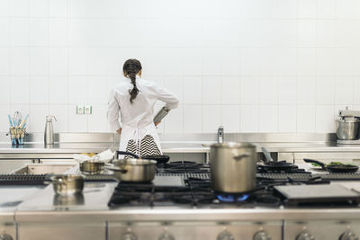 Portrait of female friends with hands in kitchen