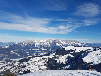 Scenic view of snowcapped mountains against blue sky