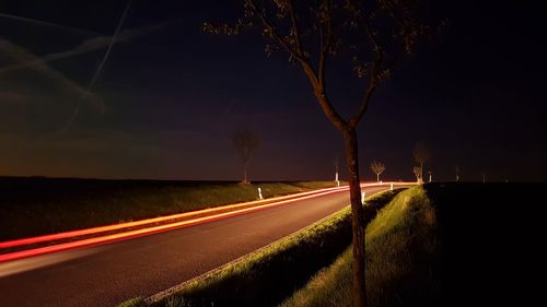 Light trails on road in city at night