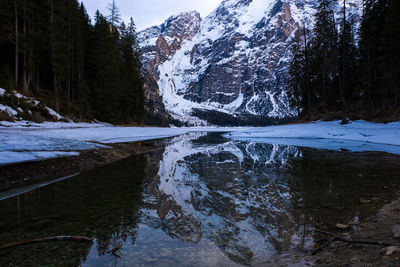 Scenic view of lake by snowcapped mountains during winter