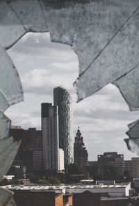 City skyline against cloudy sky