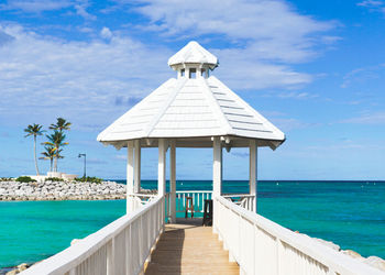 Gazebo by sea against sky