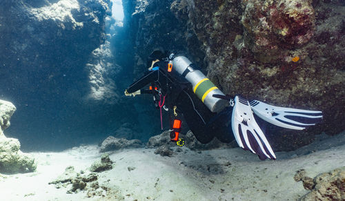 Scuba diver exploring a canyon at the great barrier reef in australia