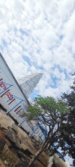 Low angle view of building against cloudy sky