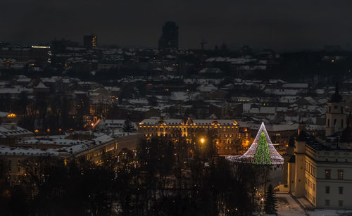 High angle view of illuminated buildings in city at night