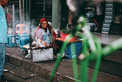 Blurred motion of woman walking in street market