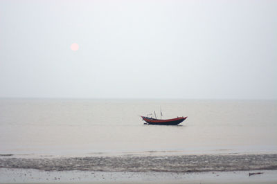 Boat in sea against clear sky