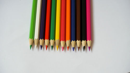 Close-up of colored pencils against white background