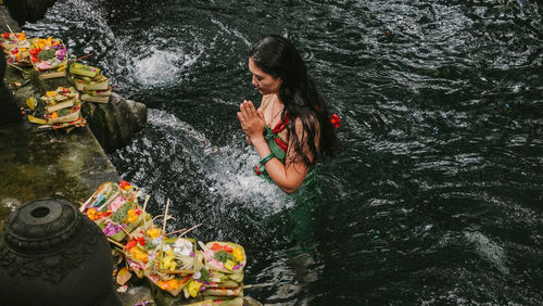 High angle view of woman on rock by river