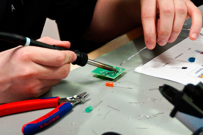 Midsection of man working on table