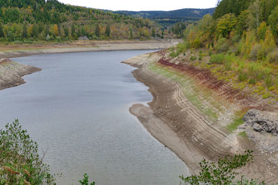 High angle view of river amidst trees against sky