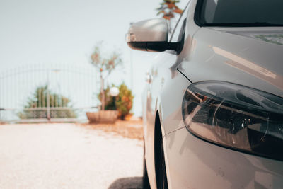 Close up of volvo v40 car with focus on foreground against olive tree and sky