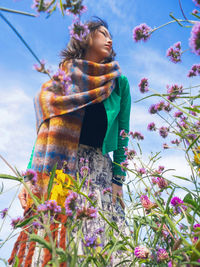 Portrait of woman standing against trees