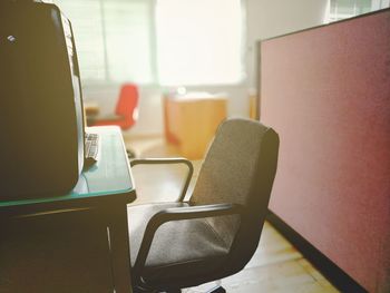 Empty chair at desk in office