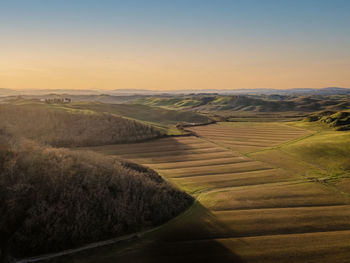 Scenic view of field against sky during sunset