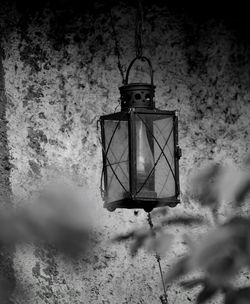 Low angle view of lantern hanging on wall