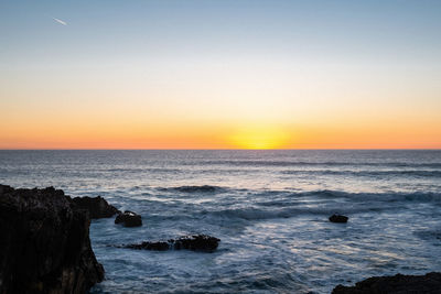 Scenic view of sea against sky during sunset