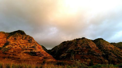 Scenic view of mountains against cloudy sky