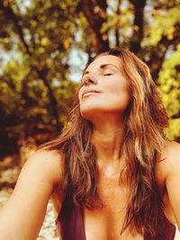 Close-up portrait of a young woman in tree