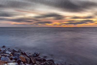 Scenic view of sea against dramatic sky