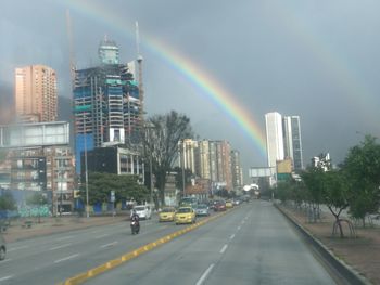 View of rainbow over city buildings