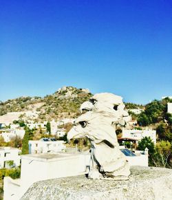 Sculpture on mountain against clear sky