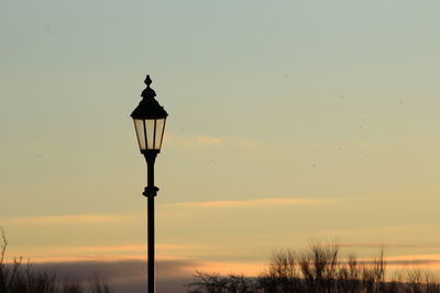 Low angle view of street light against sky at night