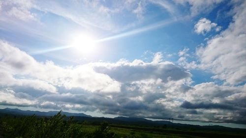 Scenic view of landscape against cloudy sky