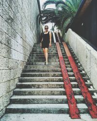 Low angle view of woman standing on staircase