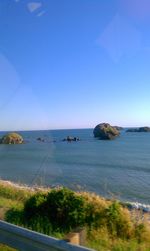 Scenic view of sea against clear blue sky