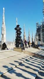 Statue in city against clear sky