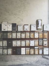 Rusty public mailboxes on wall