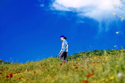 Full length of man standing on grassy field
