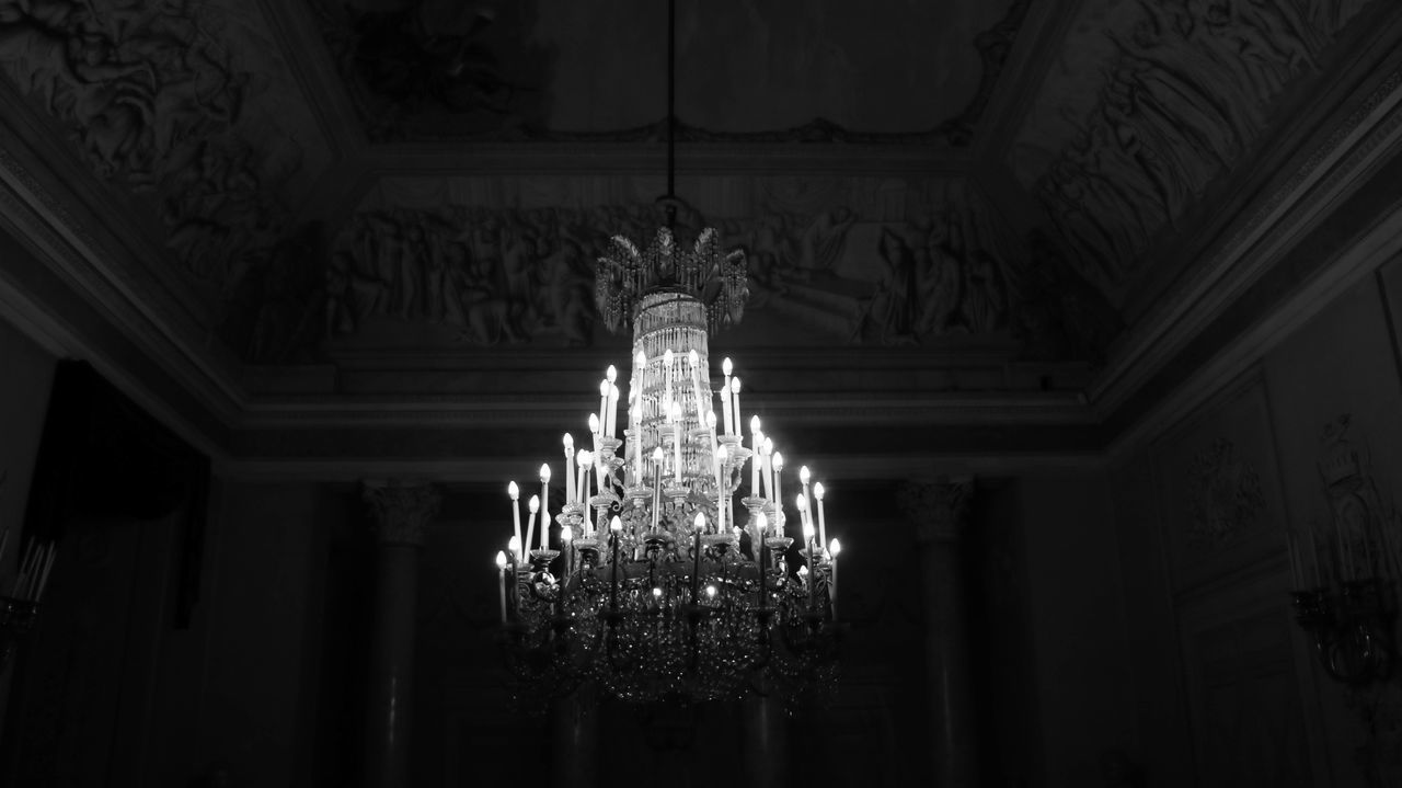 LOW ANGLE VIEW OF ILLUMINATED LIGHTS HANGING IN CORRIDOR