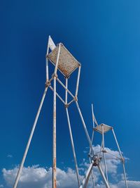 Low angle view of traditional windmill against blue sky