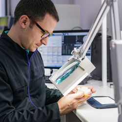 Dentist looking at dentures in clinic