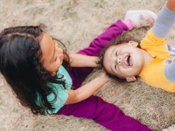 High angle view of cute sibling playing outdoors