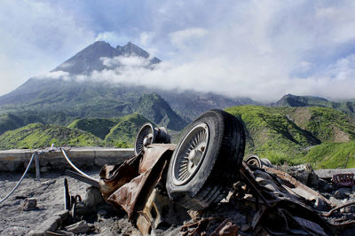 Abandoned truck on mountain against sky