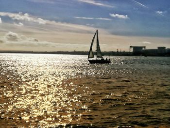 Sailboat sailing on sea against sky