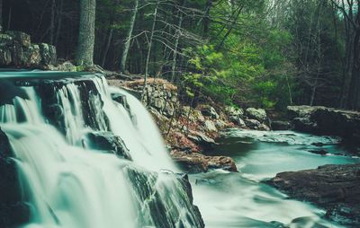 Close-up of waterfall by sea against sky