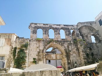 Low angle view of historical building against clear blue sky