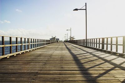 Railing on bridge against sky