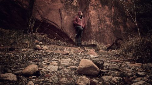 Man standing on rock in forest