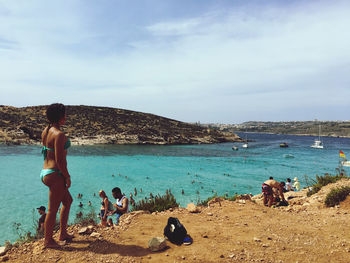 People on beach against sky